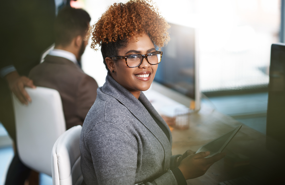 Its the perfect job for me. High angle portrait of an attractive young businesswoman working at her desk in a modern office.
